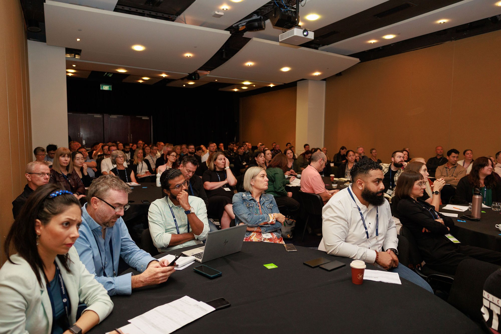 People sitting in conference room listening attentively to DW Conference presenter